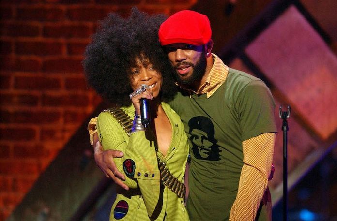 Erykah Badu and Common wearing green and red hat